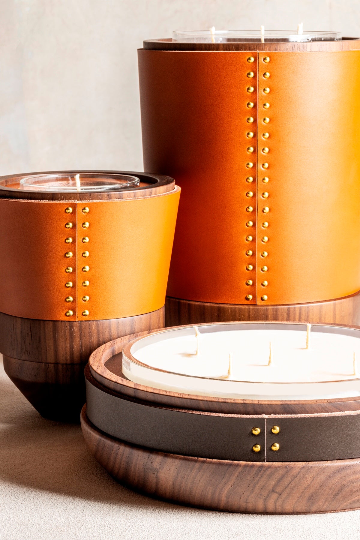 Rabitti 1969 Toiles De Noyer Candle Holders | Crafted from rich walnut wood with fine saddle leather inserts and golden tack details | Available in three sizes for versatile decor | Home Decor | 2Jour Concierge, your luxury lifestyle shop