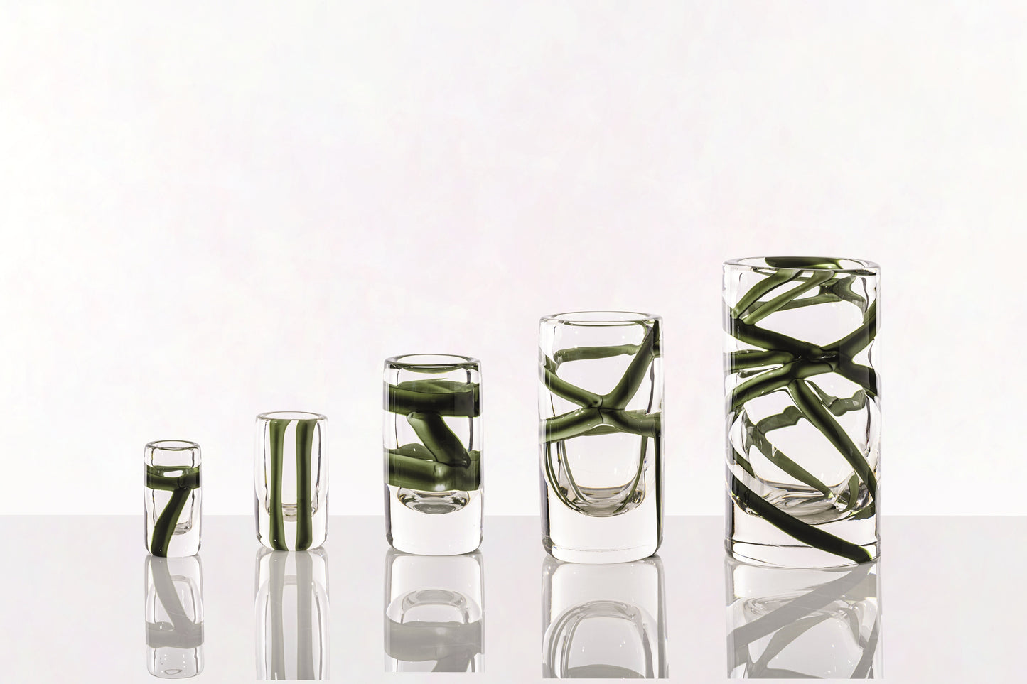 Cilindro Murano Glass Vase by Venini | New color variations featuring transparent bands in Tea or Green Apple-Milk White, creating an elegant contrast with crystal clear glass | Tea color version adorned with glazed Gold decorations | Designer: Peter Marino | Limited edition of 349 art works | Available in heights of 14 and 40 centimeters | Home Decor Vases | 2Jour Concierge, your luxury lifestyle shop
