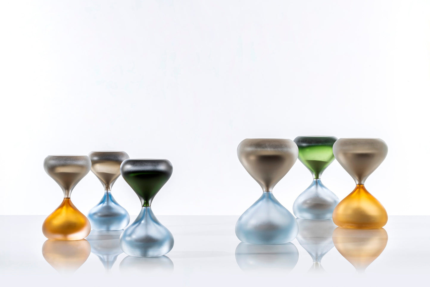 Clessidre Sommerse by Venini | New series enriching the collection designed by Fulvio Bianconi and Paolo Venini | Submerged glass envelops two blown glass pieces, utilizing the incalmo technique to hold the flow of grains | Timeless jewels representing the relentless passage of time | Home Decor | 2Jour Concierge, your luxury lifestyle shop