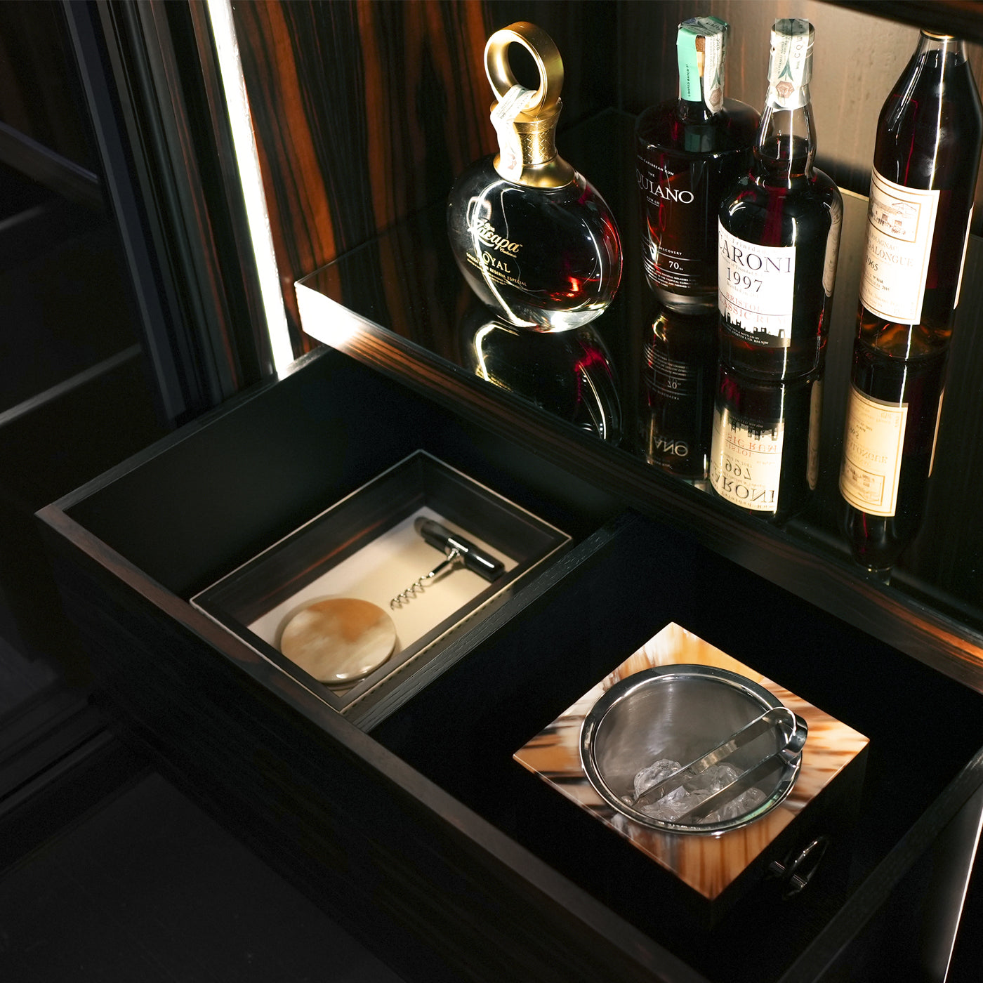 Arcahorn Manhattan Wine Cellar Cabinet | Matte Makassar Ebony Veneer | Burnished Brass Handles with Multifaceted Horn Gems | Backlit Interior in Ebony and Oak Veneer | Sliding Trays for Wine, Champagne, and Magnum Bottles | Multi-temperature Refrigeration System | Explore Luxury Home Accessories at 2Jour Concierge, #1 luxury high-end gift & lifestyle shop