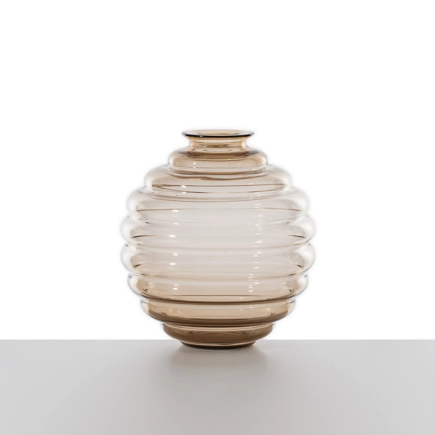 Venini Deco Vase | A Murano glass vase defined by rhythmic, flowing rings that expand and contract in a graceful, dance-like motion | Originally designed by Napoleone Martinuzzi in 1930, the Deco vase embodies timeless elegance and sculptural harmony | The repeated circular forms create a play of ripples and reflections, capturing the essence of movement | A celebrated icon of Venetian glass artistry | Design by Venini | Tableware & decorative objects | 2Jour Concierge, your luxury lifestyle shop.