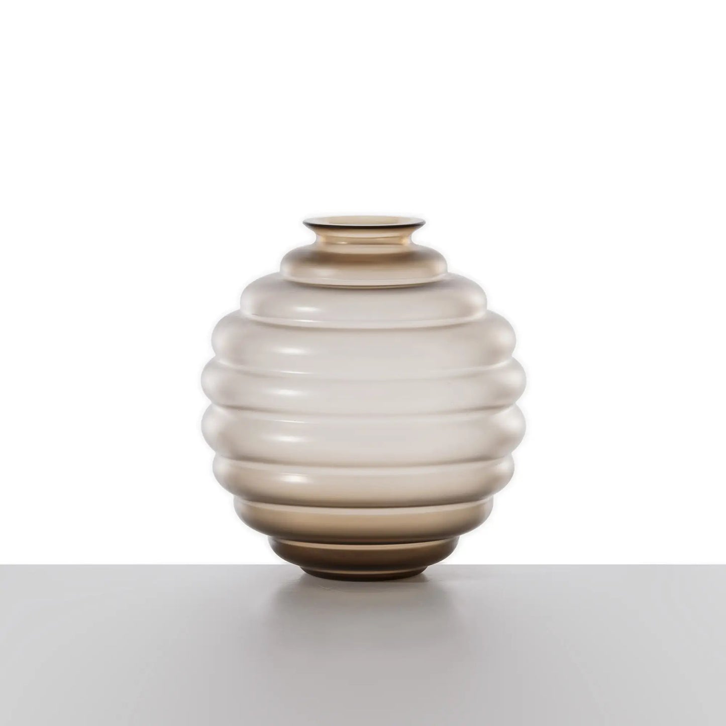 Venini Deco Vase | A Murano glass vase defined by rhythmic, flowing rings that expand and contract in a graceful, dance-like motion | Originally designed by Napoleone Martinuzzi in 1930, the Deco vase embodies timeless elegance and sculptural harmony | The repeated circular forms create a play of ripples and reflections, capturing the essence of movement | A celebrated icon of Venetian glass artistry | Design by Venini | Tableware & decorative objects | 2Jour Concierge, your luxury lifestyle shop.