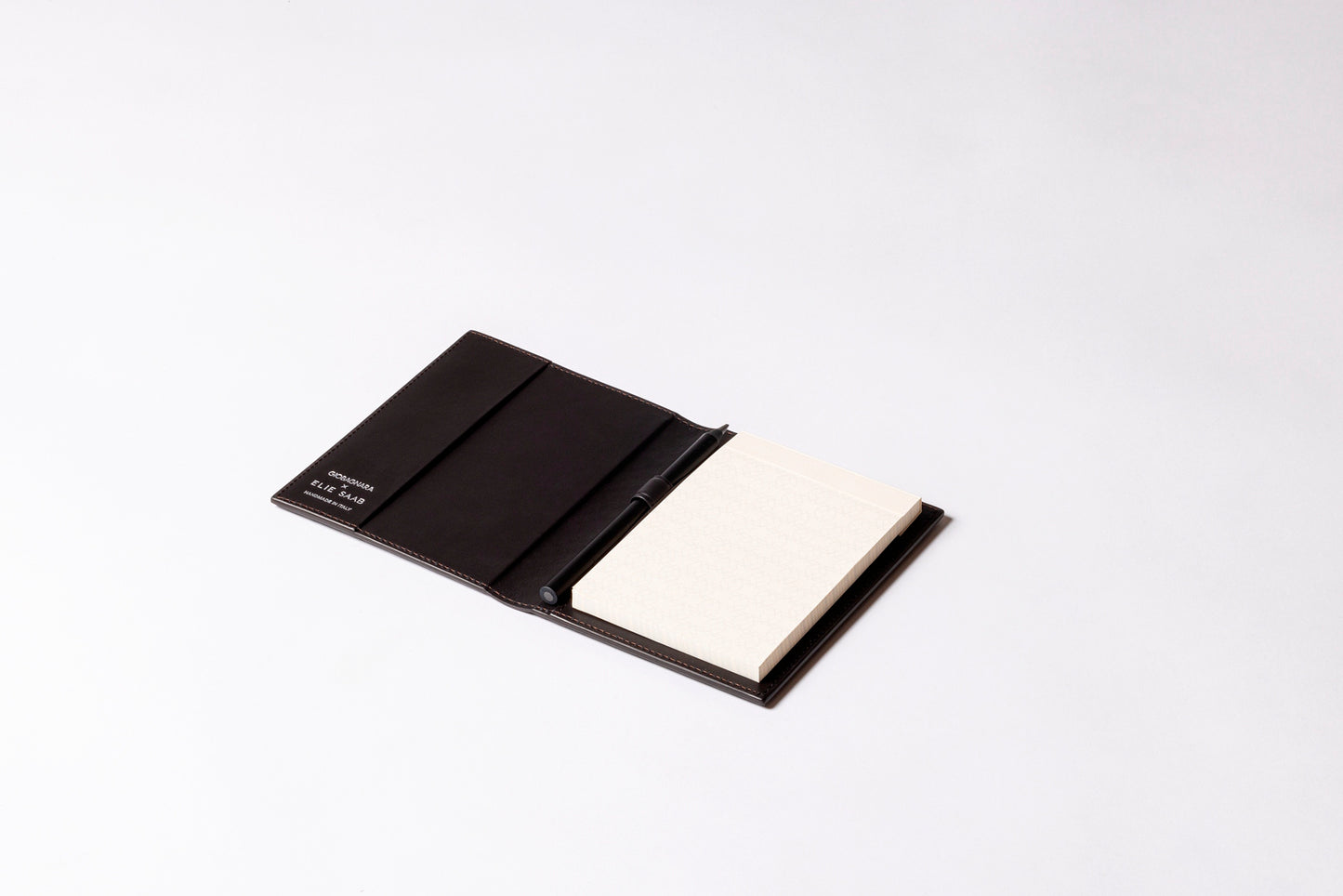 Giobagnara x Elie Saab Monogram Notepad Holder | Padded leather cover featuring the Elie Saab Monogram pattern and suede lining | Includes an elastic pencil holder with pen and a notepad with 70 ivory sheets | Available in small (A6), medium (A5), and large (A4) sizes | Office Accessories | 2Jour Concierge, your luxury lifestyle shop
