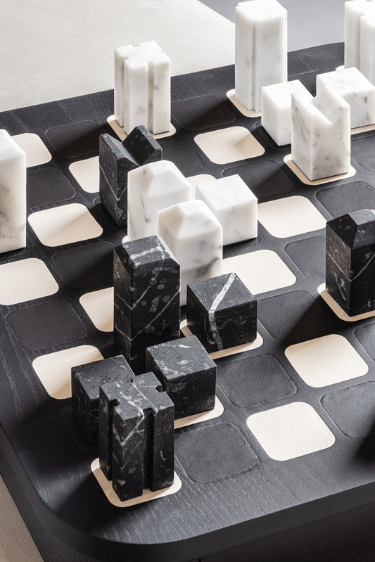 Giobagnara x Elie Saab Monogram Big Chess Game Set | Wood structure with fine leather inserts on top and a leather base featuring the Elie Saab Monogram pattern | Base encases magnetic drawers for storing playing pieces | Includes two sets of chess pieces made from white Carrara and black Marquinia marbles | Elegant and luxurious chess set | Home Decor and Games | 2Jour Concierge, your luxury lifestyle shop