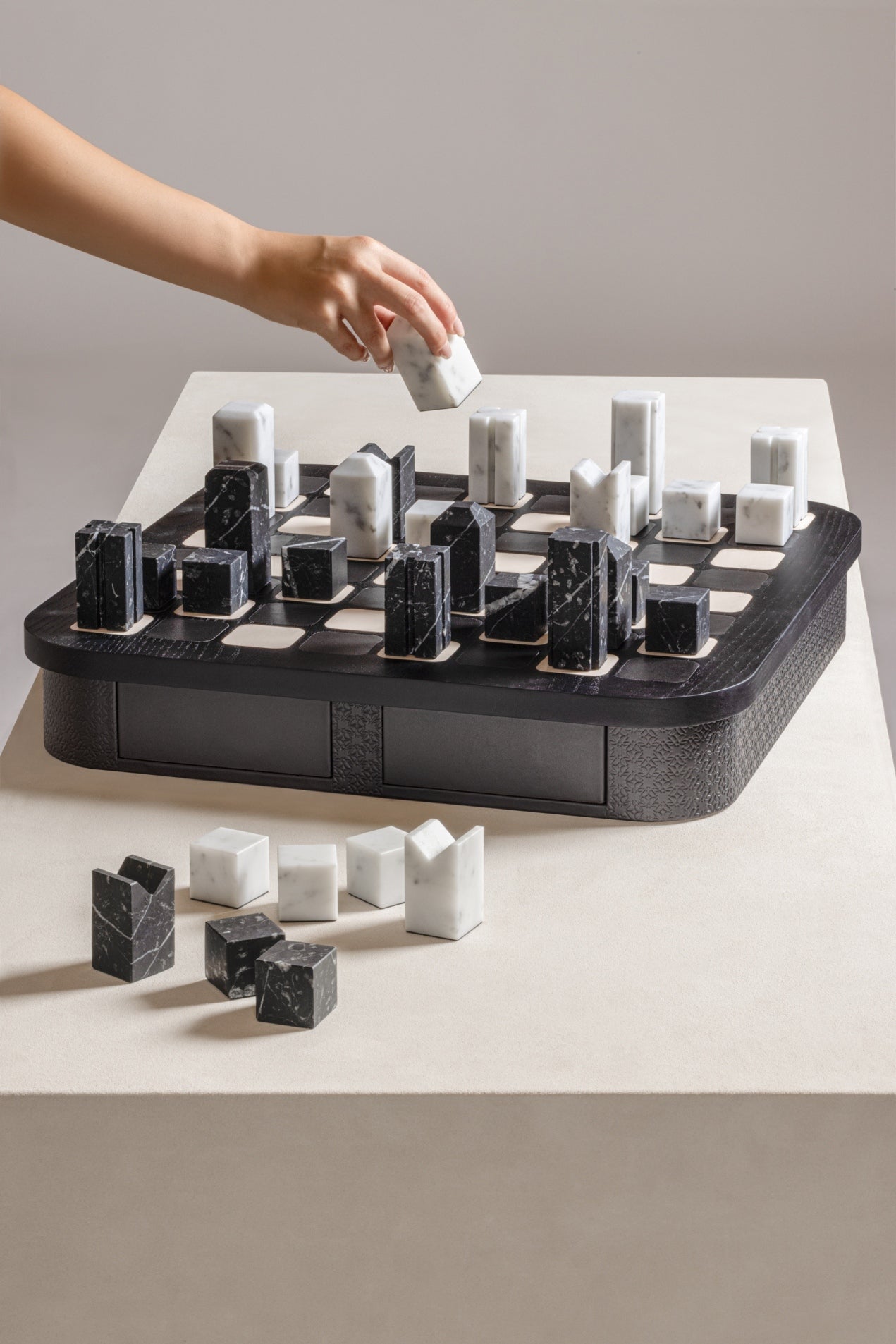 Giobagnara x Elie Saab Monogram Big Chess Game Set | Wood structure with fine leather inserts on top and a leather base featuring the Elie Saab Monogram pattern | Base encases magnetic drawers for storing playing pieces | Includes two sets of chess pieces made from white Carrara and black Marquinia marbles | Elegant and luxurious chess set | Home Decor and Games | 2Jour Concierge, your luxury lifestyle shop