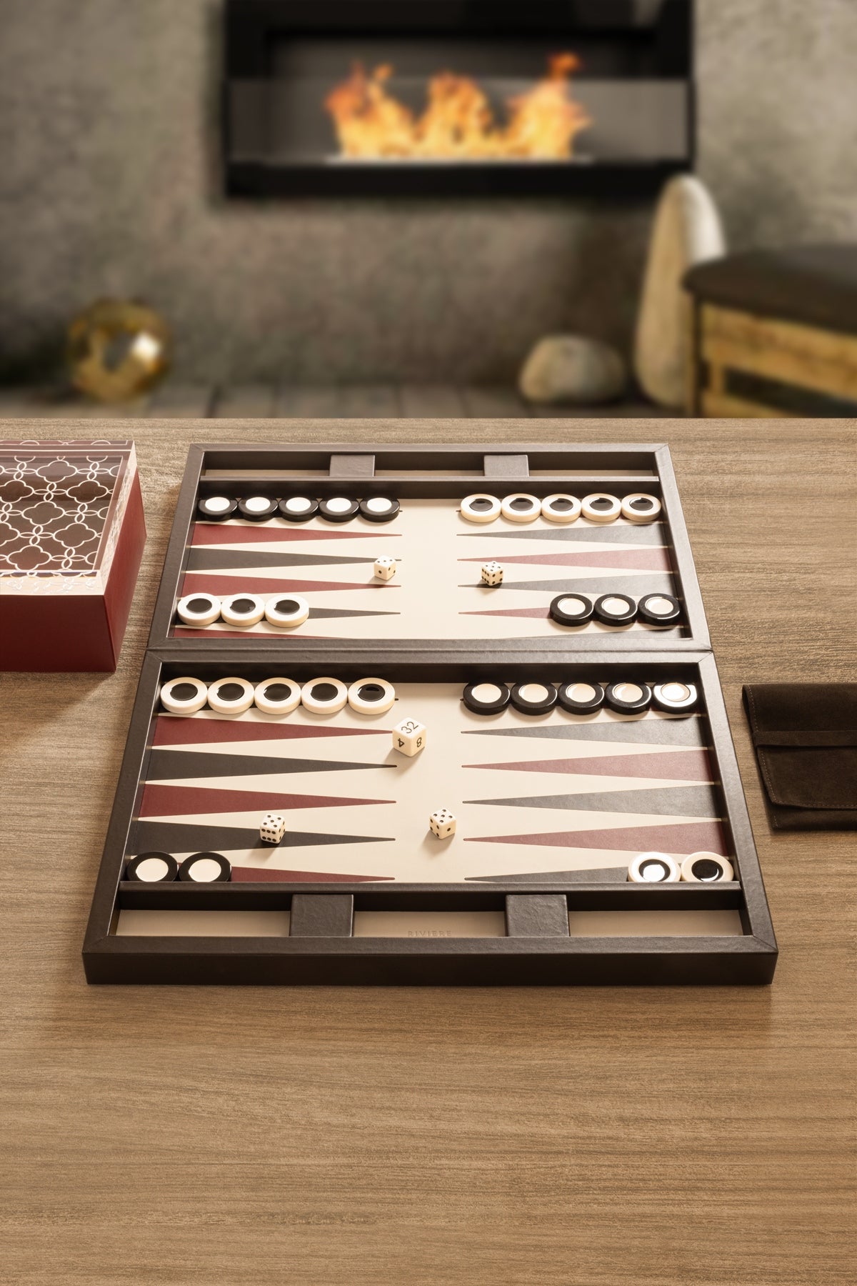 Riviere Eva Lines Backgammon Case | Leather-covered case with quilted lines padded leather lid and inlaid leather playing field | Includes two sets of shiny plexiglass backgammon checkers, 4 dice, and a doubling cube | Comes with a fine suede bag for storing pieces | Elegant and sophisticated design | Home Decor and Games | 2Jour Concierge, your luxury lifestyle shop