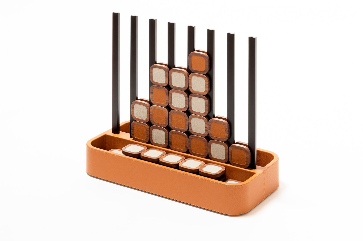 Giobagnara x Poltrona Frau connect 4 | Leather-covered base with walnut wood playing pieces featuring fine leather inserts | Accented with burnished brushed bronze details | A stylish, elevated take on a timeless game | Entirely made in Pelle Frau® | Home decor & game sets | 2Jour Concierge, your luxury lifestyle shop