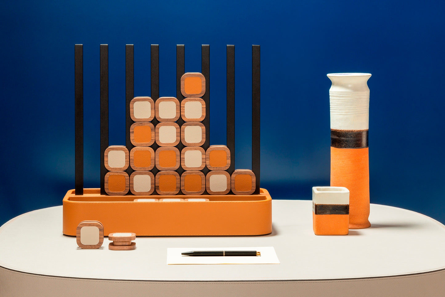 Giobagnara x Poltrona Frau connect 4 | Leather-covered base with walnut wood playing pieces featuring fine leather inserts | Accented with burnished brushed bronze details | A stylish, elevated take on a timeless game | Entirely made in Pelle Frau® | Home decor & game sets | 2Jour Concierge, your luxury lifestyle shop