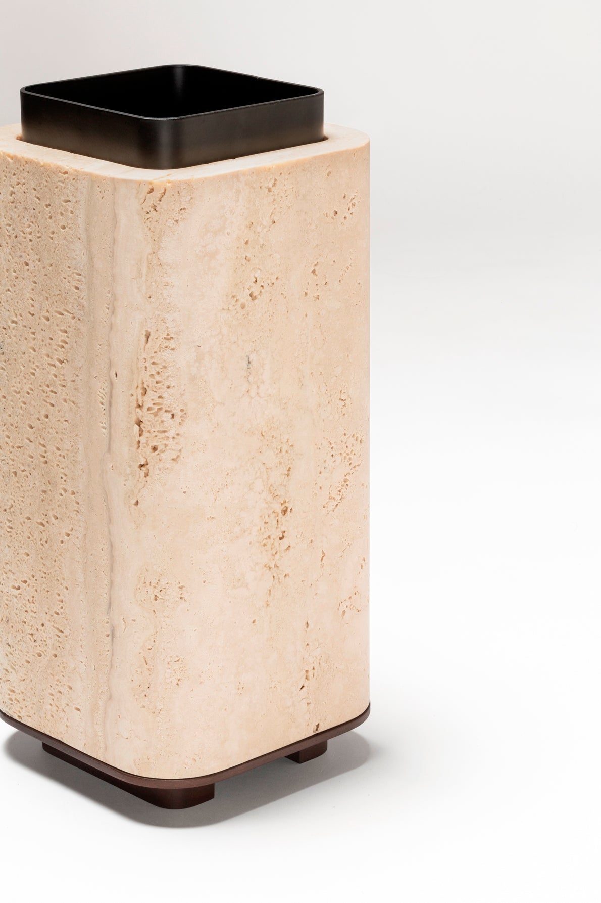 Giobagnara x Glenn Sestig Lloyd Vase | Travertine structure with a removable burnished-brushed bronze container seated on a walnut- or wenge-finished wood base, blending organic stone with metallic warmth | Crafted in Italy by Giobagnara in collaboration with designer Glenn Sestig | Home Decor / Vases | 2Jour Concierge, your luxury lifestyle shop