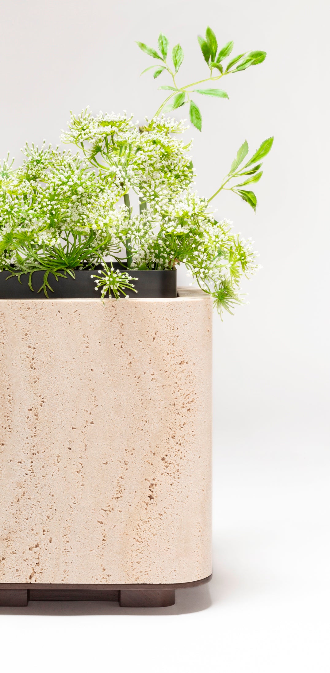 Giobagnara x Glenn Sestig Lloyd Vase | Travertine structure with a removable burnished-brushed bronze container seated on a walnut- or wenge-finished wood base, blending organic stone with metallic warmth | Crafted in Italy by Giobagnara in collaboration with designer Glenn Sestig | Home Decor / Vases | 2Jour Concierge, your luxury lifestyle shop