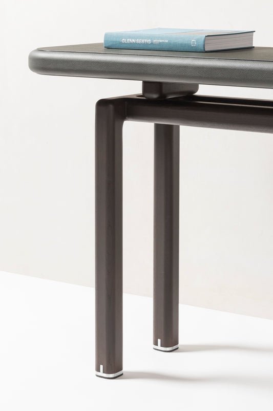 Giobagnara × Glenn Sestig | Lloyd Console: Leather and Canaletto walnut with iron or brushed bronze feet | Furniture / Console Tables + Étageres | 2Jour Concierge, your luxury lifestyle shop | modern craftsmanship, Italian design, sculptural interiors, refined living