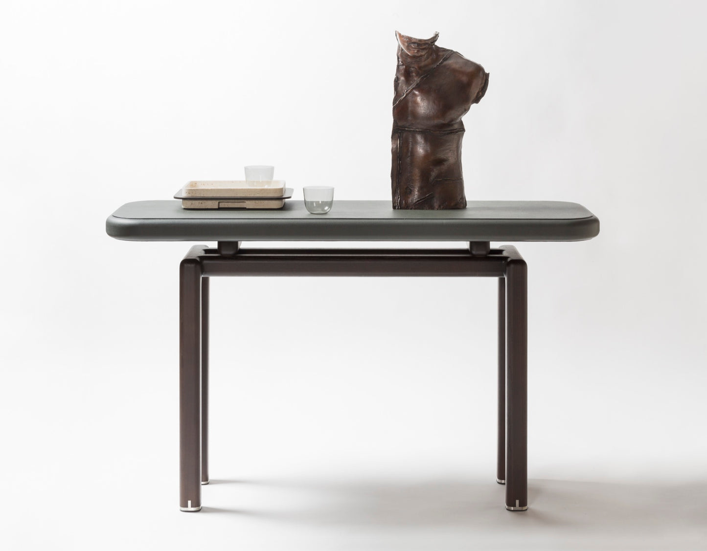 Giobagnara × Glenn Sestig | Lloyd Console: Leather and Canaletto walnut with iron or brushed bronze feet | Furniture / Console Tables + Étageres | 2Jour Concierge, your luxury lifestyle shop | modern craftsmanship, Italian design, sculptural interiors, refined living