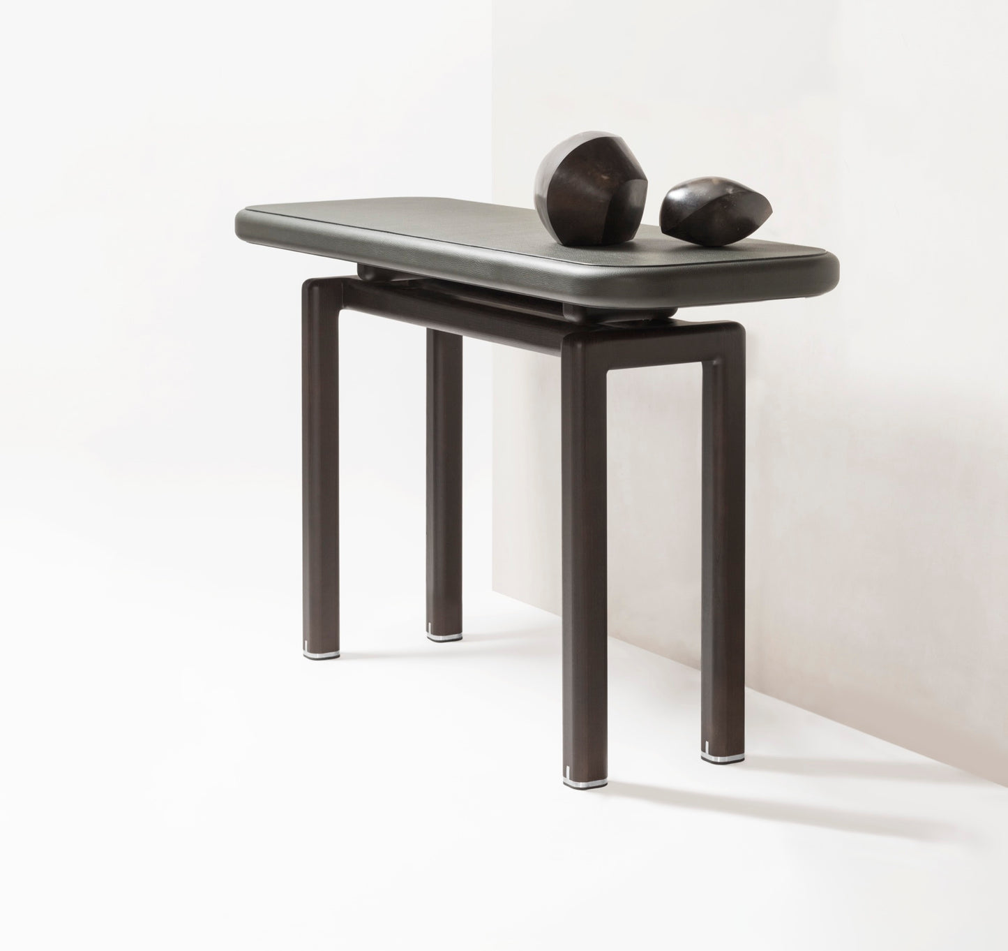 Giobagnara × Glenn Sestig | Lloyd Console: Leather and Canaletto walnut with iron or brushed bronze feet | Furniture / Console Tables + Étageres | 2Jour Concierge, your luxury lifestyle shop | modern craftsmanship, Italian design, sculptural interiors, refined living