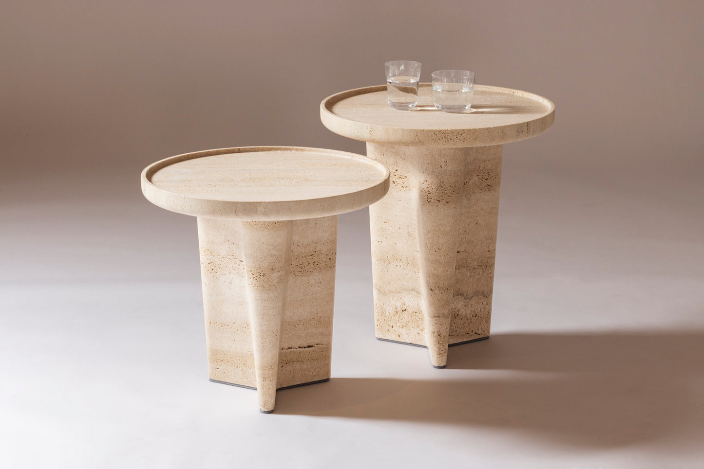 Giobagnara × Glenn Sestig Tanell | Travertine Round Side Tables: Sculptural base in classic or titanium travertine with smooth circular top | Furniture / Side Tables + Bar Tables | 2Jour Concierge, your luxury lifestyle shop | luxury interiors, refined living, boutique hotels, designer furniture, yacht décor, hospitality spaces, contemporary stone design
