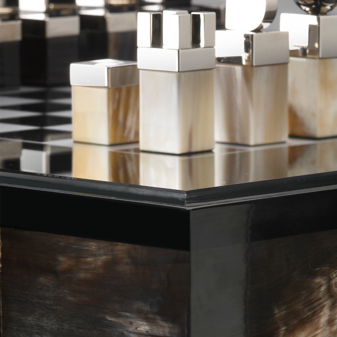 Alfio Chess Table by Arcahorn | Chessboard table in dark horn and wood | Lacquered black gloss finish | Top in tempered smoked glass with silkscreened silver chessboard | Chessmen crafted from horn and palladium plated brass | Furniture and Chess Tables | 2Jour Concierge, your luxury lifestyle shop
