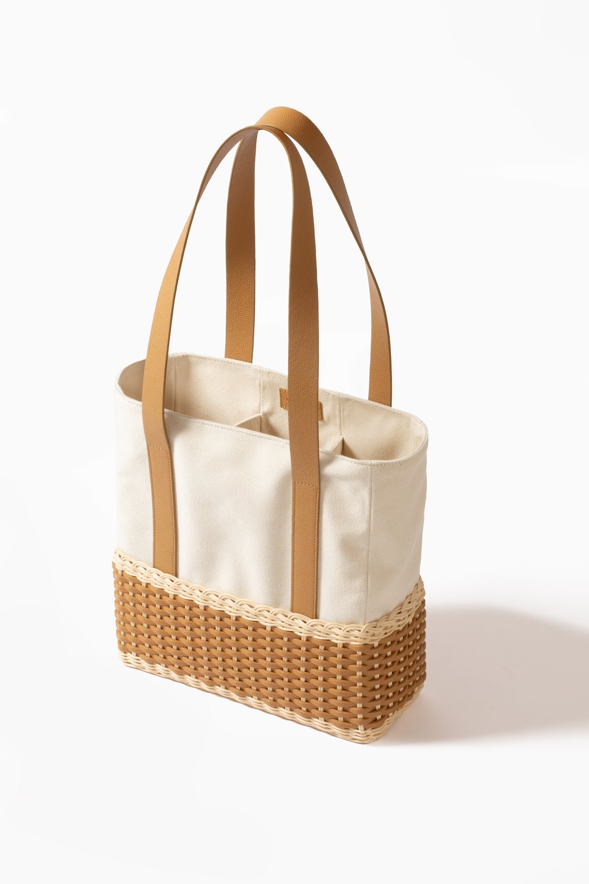 Pigment France Talais Bottle Carrier | Rigid base in woven leather and rattan with soft cream-colored cotton lining and partitions for bottles | Long shiny calfskin handles add elegance and functionality | Sophisticated design enhancing premium materials | Can accommodate multiple bottles | Home Decor and Accessories | 2Jour Concierge, your luxury lifestyle shop