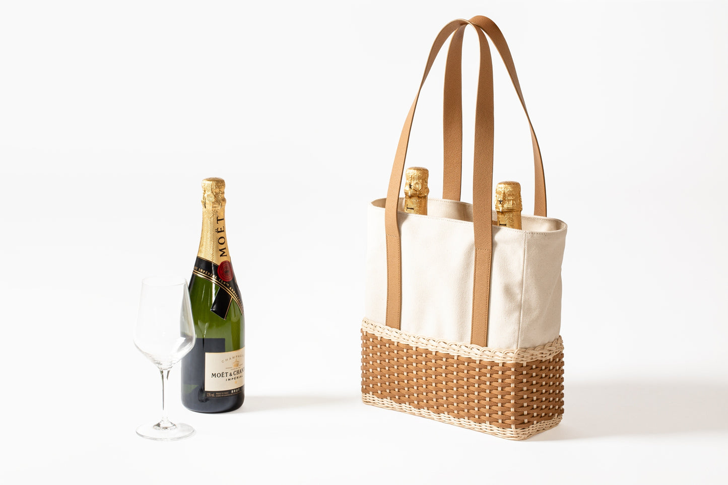 Pigment France Talais Bottle Carrier | Rigid base in woven leather and rattan with soft cream-colored cotton lining and partitions for bottles | Long shiny calfskin handles add elegance and functionality | Sophisticated design enhancing premium materials | Can accommodate multiple bottles | Home Decor and Accessories | 2Jour Concierge, your luxury lifestyle shop