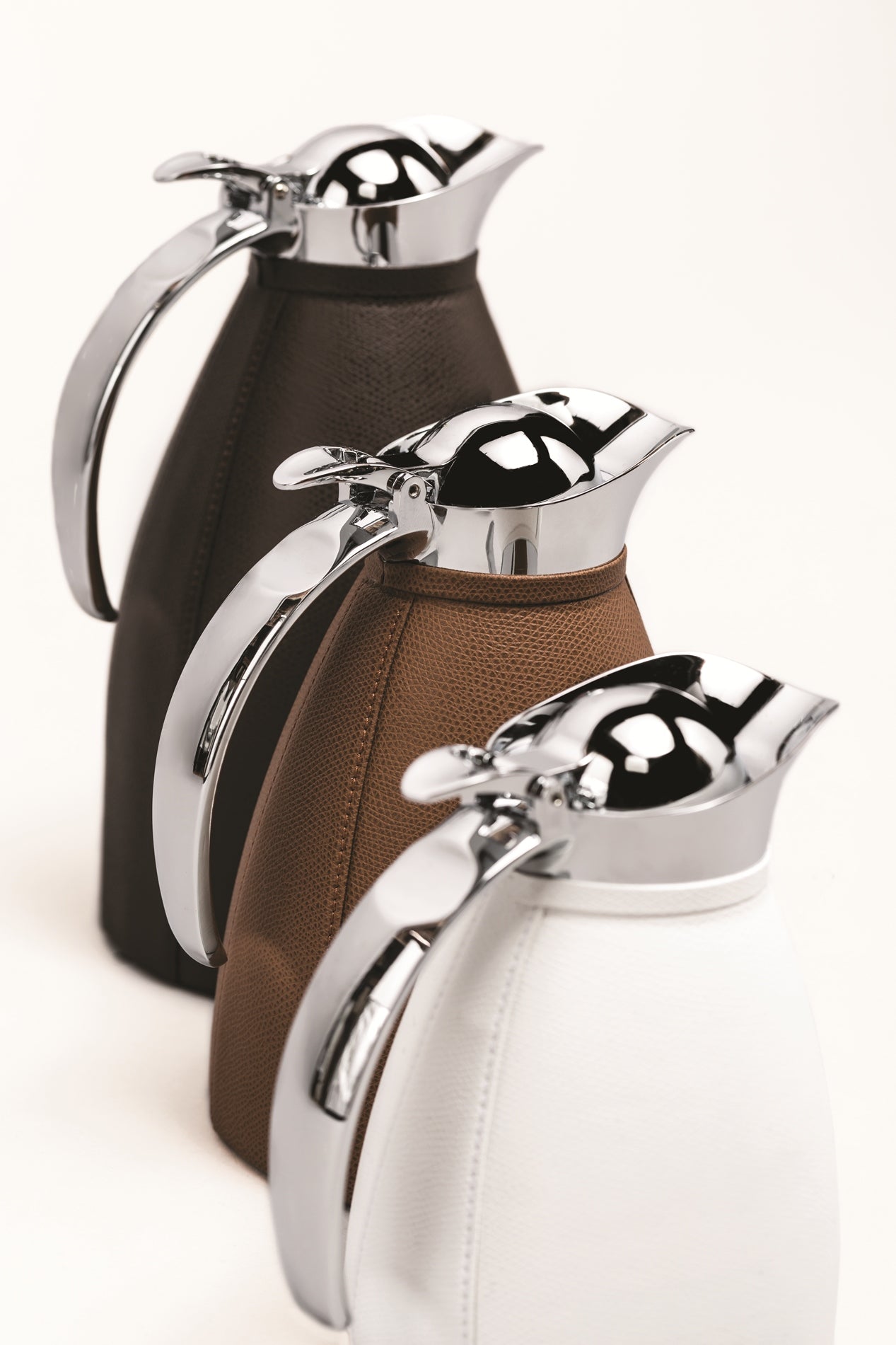 Monceau Carafe by Pigment France | Partially leather-covered insulated stainless steel carafe with chrome-plated finish. Two-chamber structure maintains liquid temperatures. Precise pouring with specially developed hinged lid for one-hand operation. | Tableware and Drinkware | 2Jour Concierge, your luxury lifestyle shop