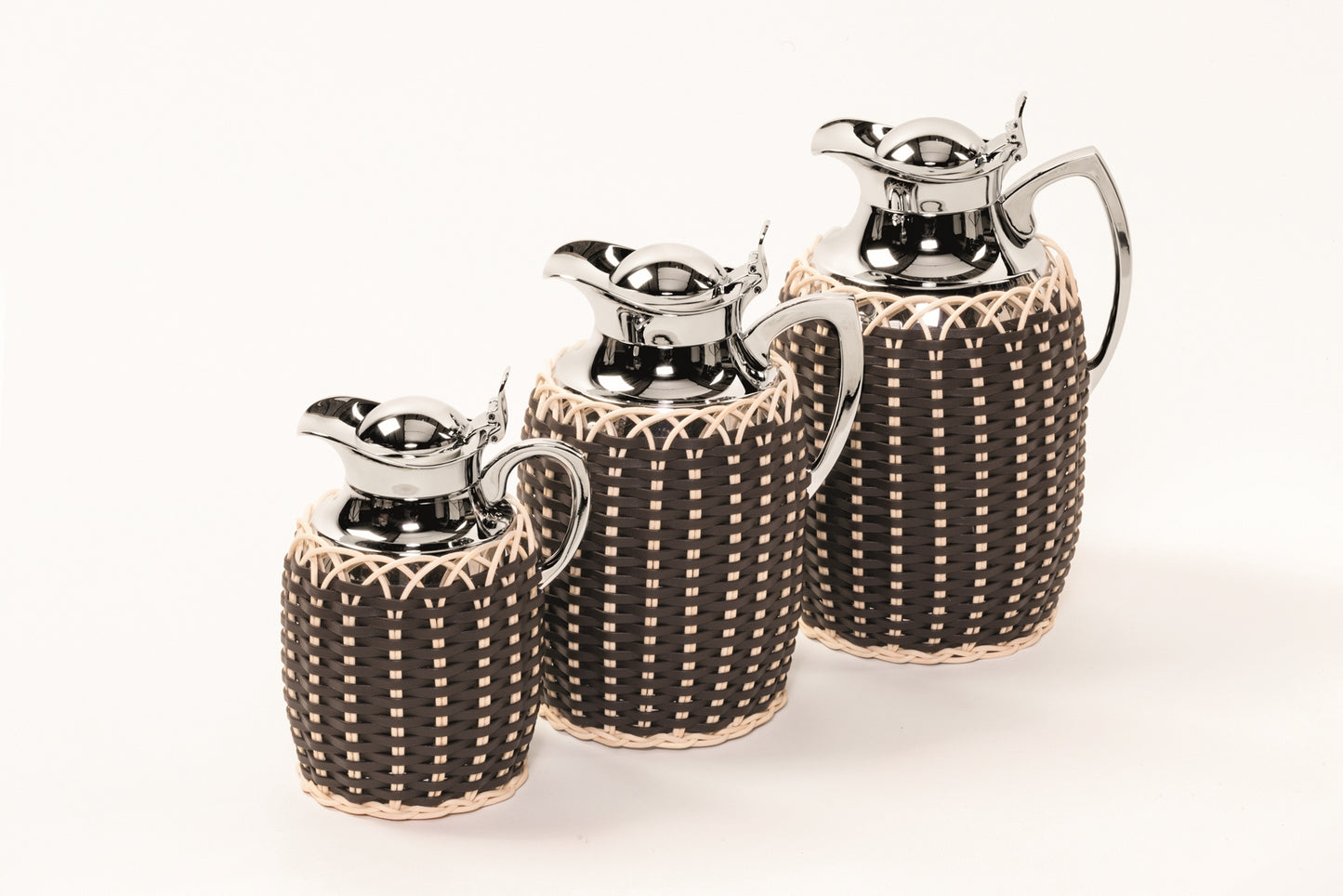 Villandry Leather & Rattan Carafe by Pigment France | Insulated brass carafe partially covered in woven leather and rattan with chrome-plated finish. Two-chamber structure maintains warm liquids for up to 12 hours and cold drinks for up to 24 hours with inner glass insert. Precise pouring with specially developed hinged lid for one-hand operation. | Tableware and Drinkware | 2Jour Concierge, your luxury lifestyle shop