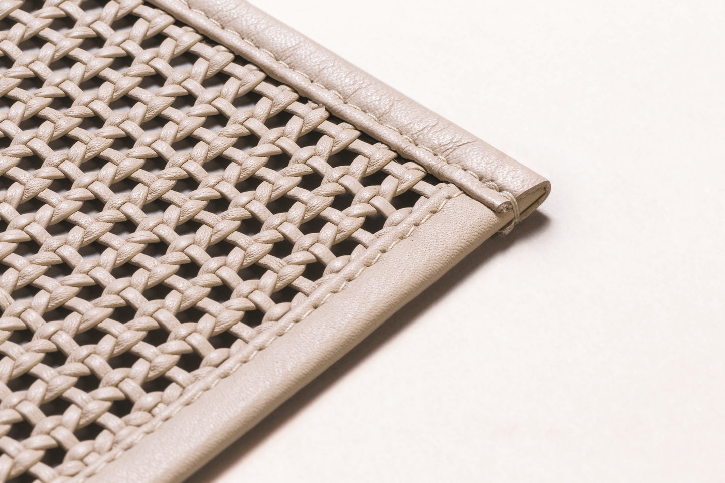 Pascale Plaited Leather Placemat by Pigment France | Handcrafted from finely cut and folded nappa strips using a weaving technique | Tableware and Dining Accessories | 2Jour Concierge, your luxury lifestyle shop