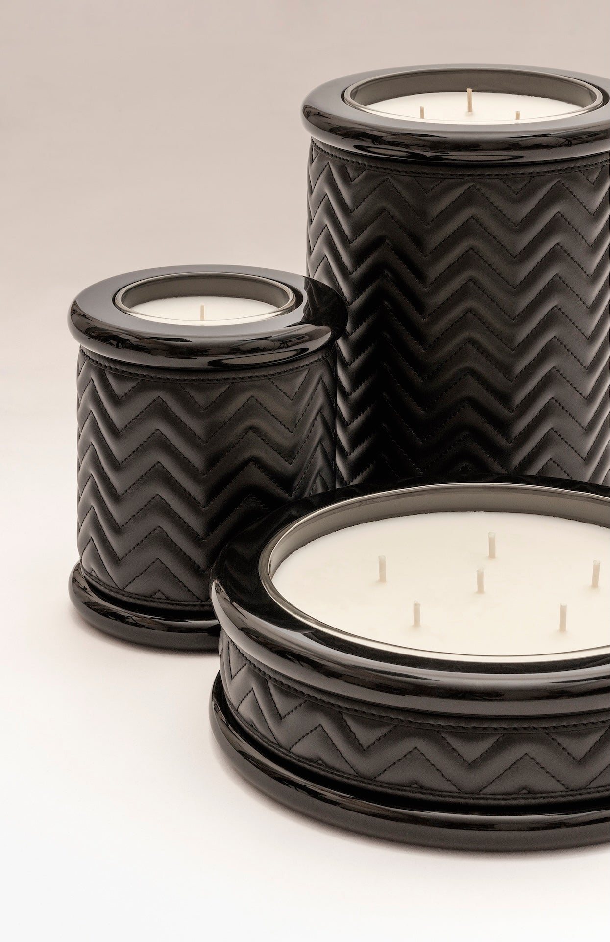 Riviere Maia | Candle Holder: Herringbone padded leather with lacquered wood and lacquer rings, available in three sizes, designed to add texture and refinement | Decor / Vases & Candle Holders | 2Jour Concierge, your luxury lifestyle shop | luxury interiors, hospitality décor, elegant living, designer home accessories, boutique hotels, refined lifestyle, yacht décor