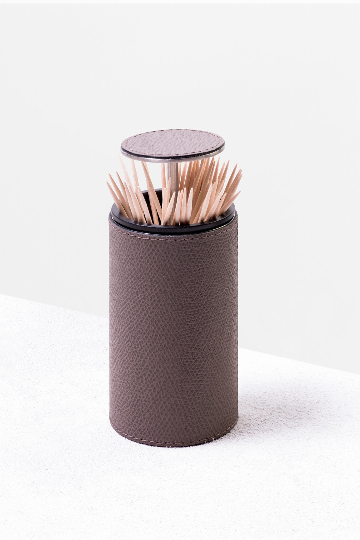 Giobagnara Otello Toothpick Holder | Partially leather-covered stainless steel structure with a discreet push-button top for easy toothpick dispensing | Crafted in Italy by Giobagnara | Serveware & Accessories / Bar Accessories | 2Jour Concierge, your luxury lifestyle shop