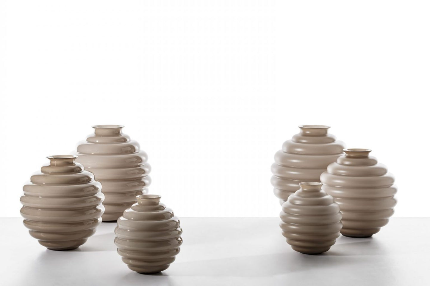 Venini Deco Vase | A Murano glass vase defined by rhythmic, flowing rings that expand and contract in a graceful, dance-like motion | Originally designed by Napoleone Martinuzzi in 1930, the Deco vase embodies timeless elegance and sculptural harmony | The repeated circular forms create a play of ripples and reflections, capturing the essence of movement | A celebrated icon of Venetian glass artistry | Design by Venini | Tableware & decorative objects | 2Jour Concierge, your luxury lifestyle shop.