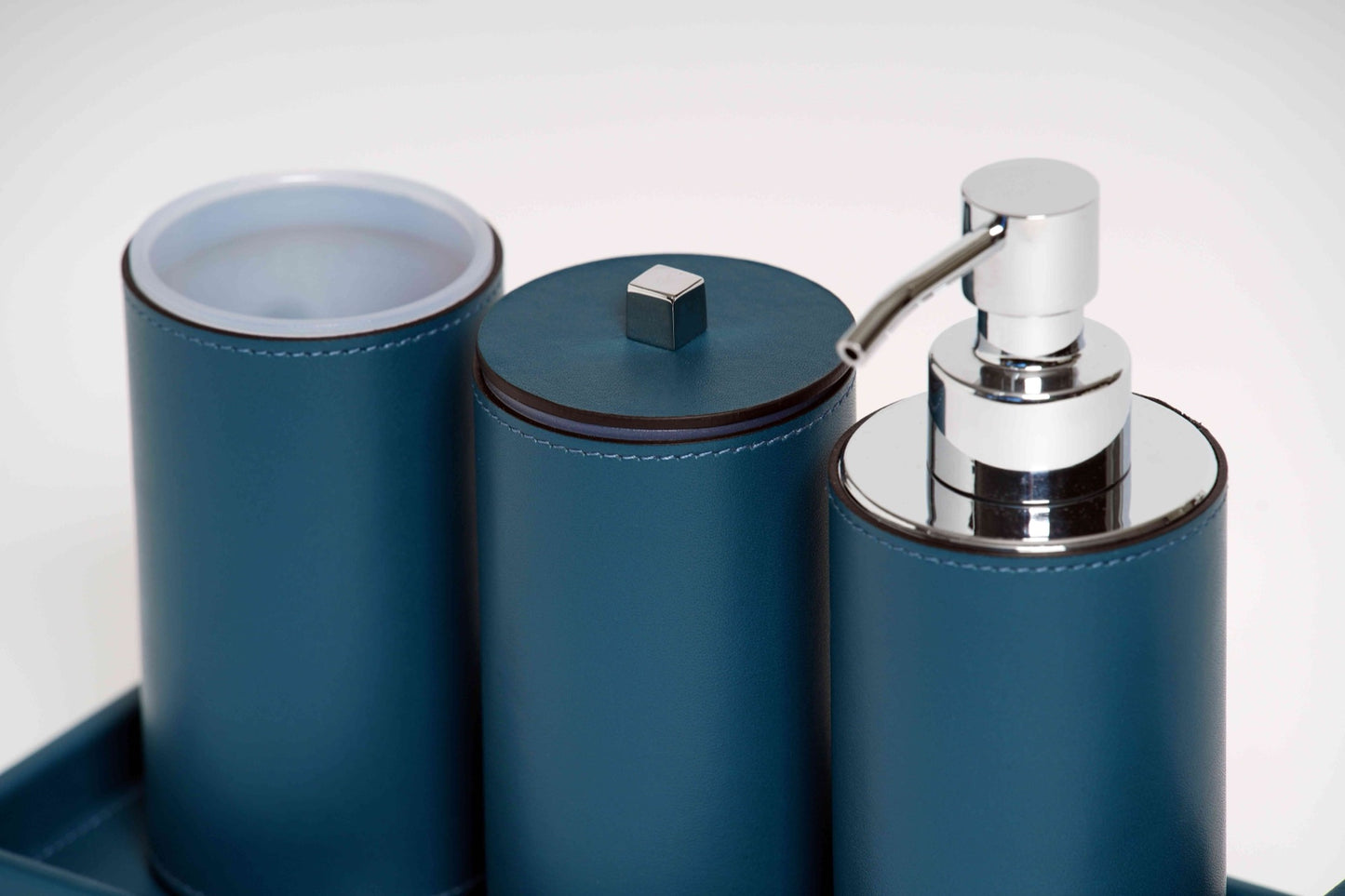 Pinetti | Poseidon Leather-Covered Soap Dispenser: Leather soap dispenser in square and round formats, chrome or shiny gold | Bathroom | 2Jour Concierge, your luxury lifestyle shop | luxury soap dispenser, leather bathroom accessory, Pinetti bathroom set, Poseidon collection, Italian luxury bathroom, designer soap dispenser, chrome gold bathroom accessories, premium vanity accessory