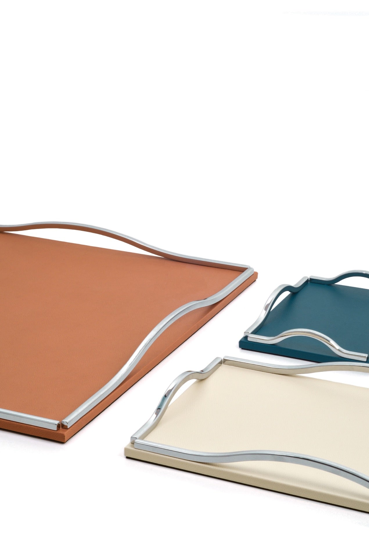 Pinetti Wave | Leather & Sculpted Metal Trays: Leather-covered tray with sculpted chrome, burnished, or gold handles, available in square and rectangular formats | Tabletop & Bar / Trays | 2Jour Concierge, your luxury lifestyle shop | luxury interiors, refined dining, elegant serving accessories, boutique hotels, contemporary décor, yacht décor, office décor, hospitality décor