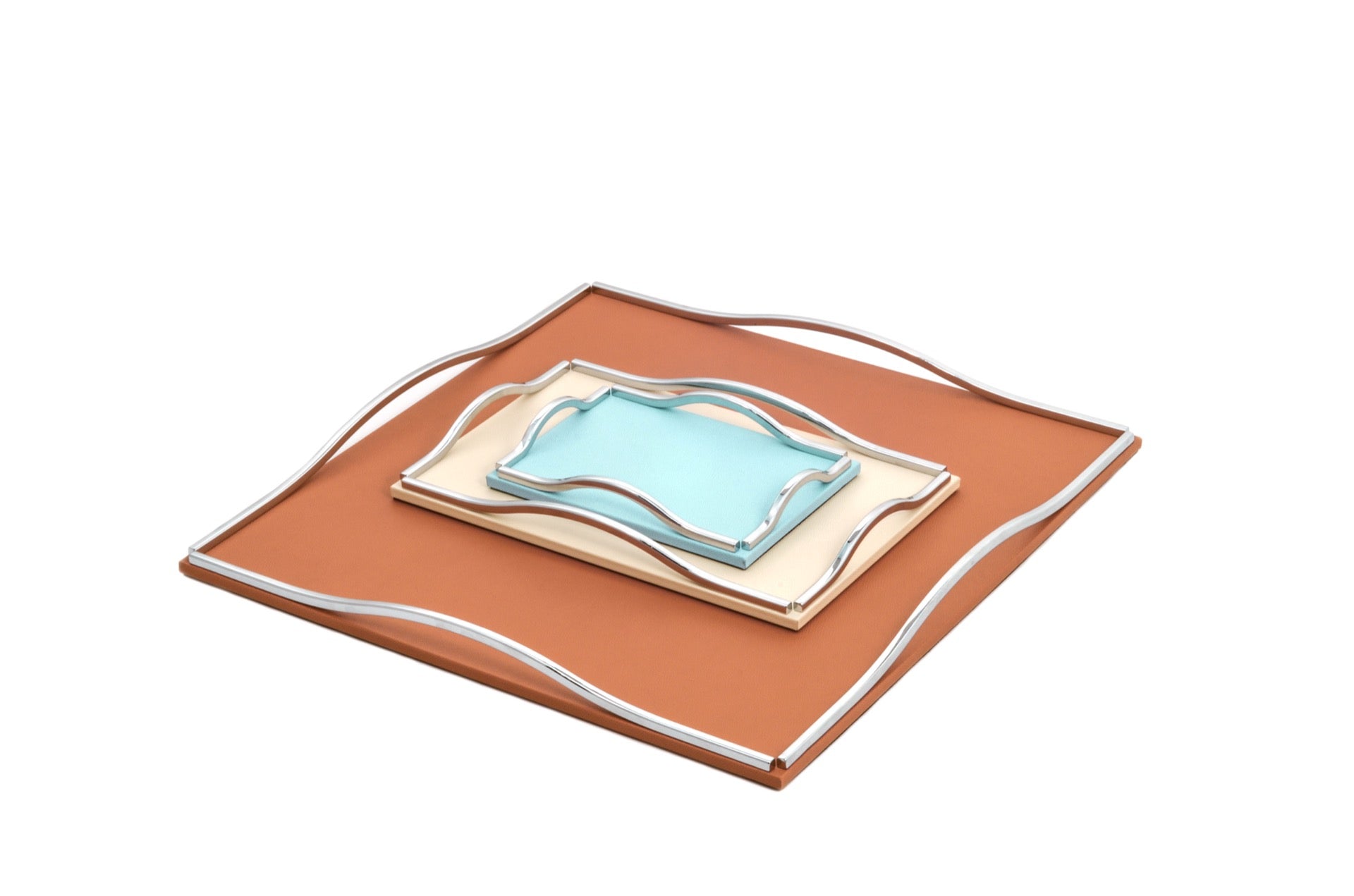 Pinetti Wave | Leather & Sculpted Metal Trays: Leather-covered tray with sculpted chrome, burnished, or gold handles, available in square and rectangular formats | Tabletop & Bar / Trays | 2Jour Concierge, your luxury lifestyle shop | luxury interiors, refined dining, elegant serving accessories, boutique hotels, contemporary décor, yacht décor, office décor, hospitality décor