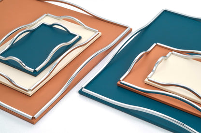 Pinetti Wave | Leather & Sculpted Metal Trays: Leather-covered tray with sculpted chrome, burnished, or gold handles, available in square and rectangular formats | Tabletop & Bar / Trays | 2Jour Concierge, your luxury lifestyle shop | luxury interiors, refined dining, elegant serving accessories, boutique hotels, contemporary décor, yacht décor, office décor, hospitality décor