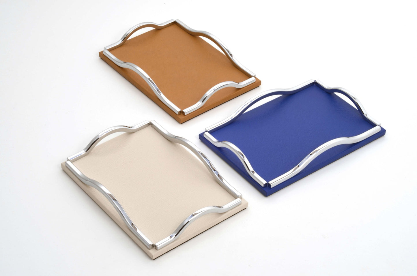 Pinetti Wave | Leather & Sculpted Metal Trays: Leather-covered tray with sculpted chrome, burnished, or gold handles, available in square and rectangular formats | Tabletop & Bar / Trays | 2Jour Concierge, your luxury lifestyle shop | luxury interiors, refined dining, elegant serving accessories, boutique hotels, contemporary décor, yacht décor, office décor, hospitality décor