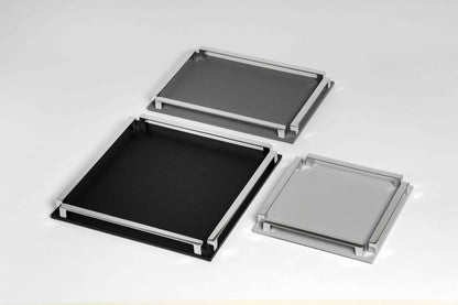 Pinetti Paul | Leather & Metal Trays: Wood base covered in leather, metal handles with chrome, burnished, or gold finish, non-slip base, available in multiple sizes | Tabletop & Bar / Trays | 2Jour Concierge, your luxury lifestyle shop | luxury interiors, refined dining, yacht décor, hospitality décor, elegant serving accessories, boutique hotels, office décor, contemporary living