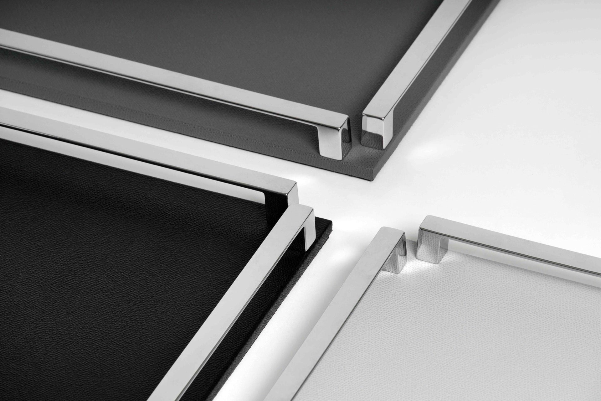 Pinetti Paul | Leather & Metal Trays: Wood base covered in leather, metal handles with chrome, burnished, or gold finish, non-slip base, available in multiple sizes | Tabletop & Bar / Trays | 2Jour Concierge, your luxury lifestyle shop | luxury interiors, refined dining, yacht décor, hospitality décor, elegant serving accessories, boutique hotels, office décor, contemporary living