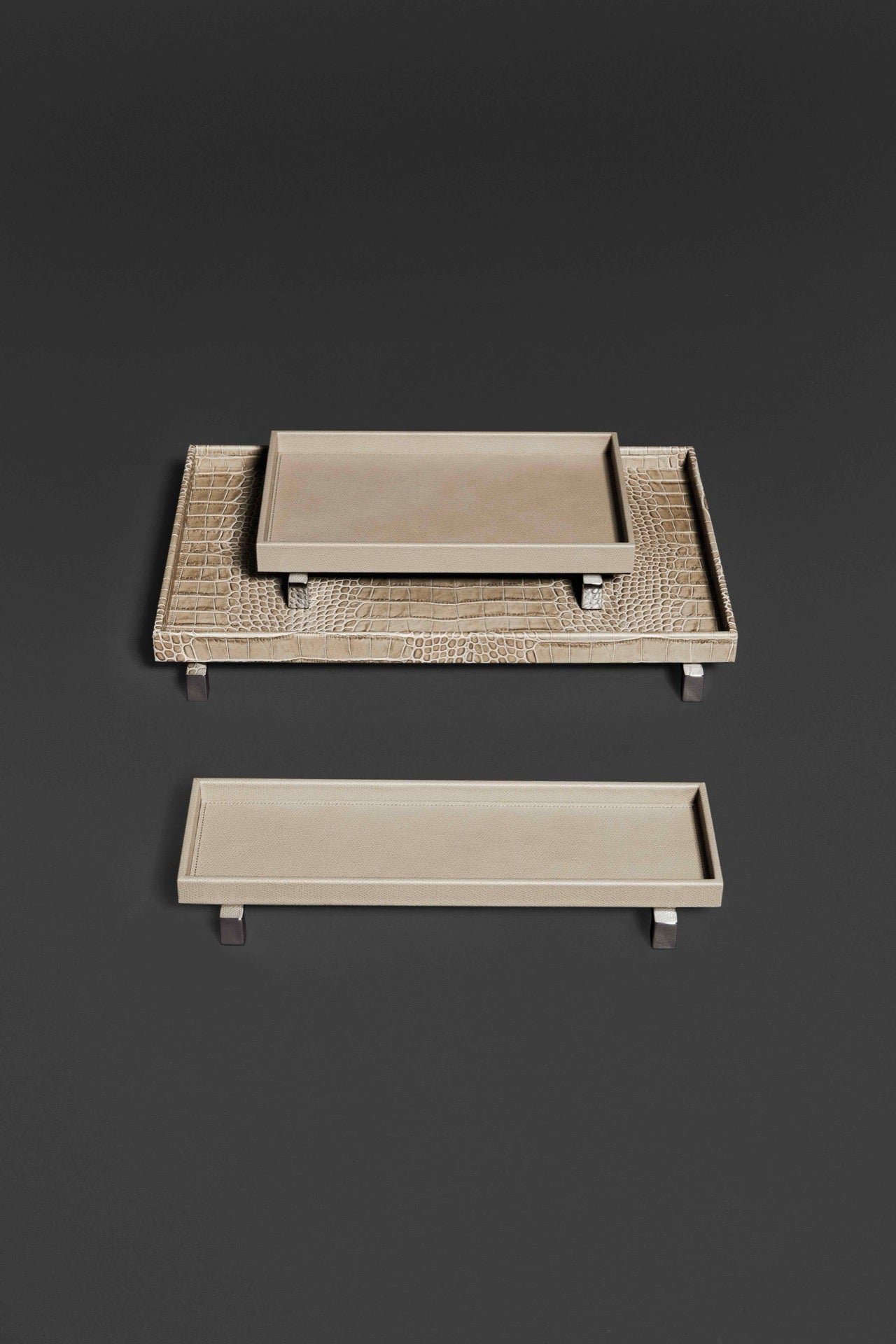 Pinetti | Rialto Leather Tray: Wood base covered in leather with metal feet in chrome, satin, or burnished finish, round and rectangular forms | Tabletop | 2Jour Concierge, your luxury lifestyle shop | luxury tray, Pinetti Rialto, leather tray with feet, raised leather tray, Italian luxury tabletop, designer serving tray, wood leather tray