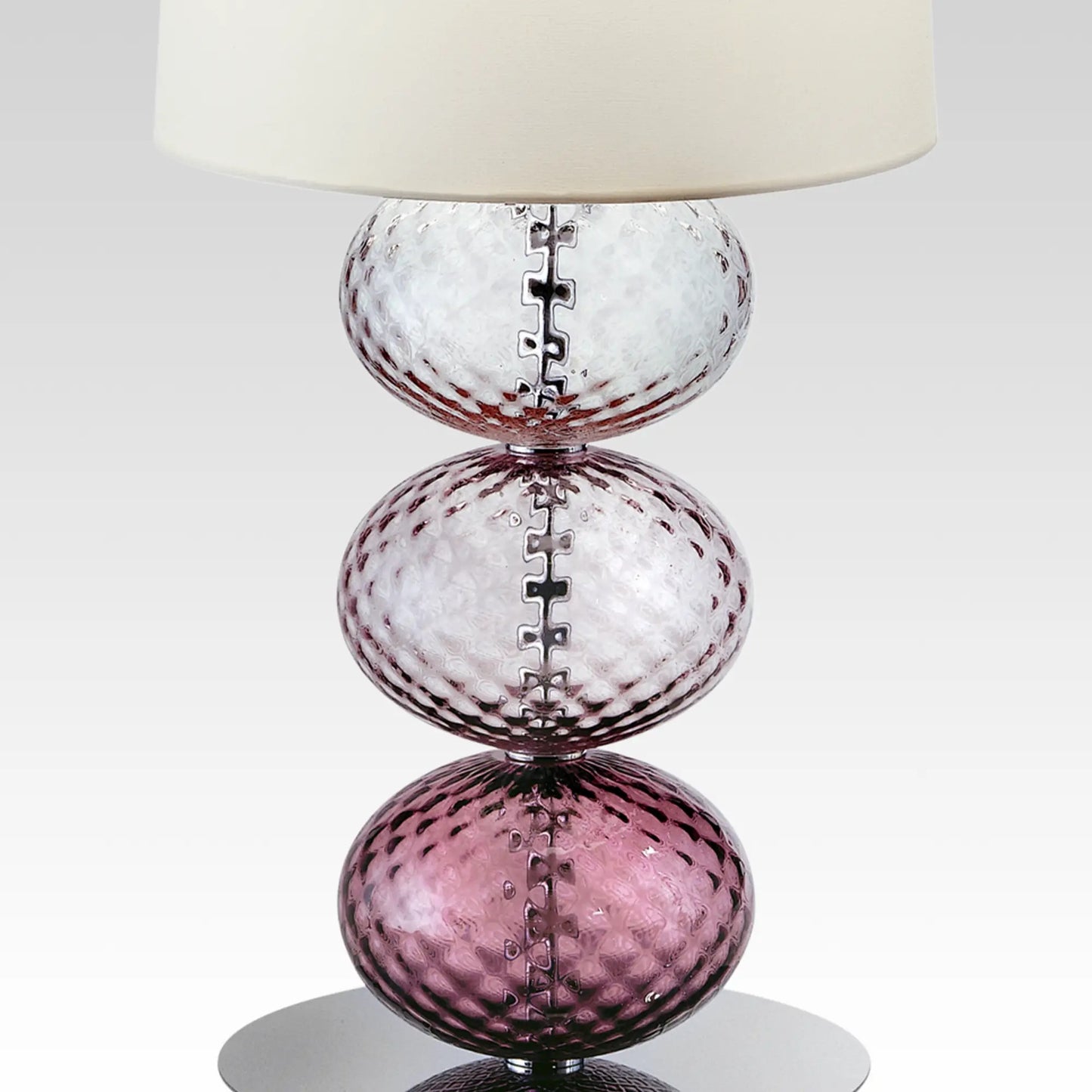 Abat-Jour Lamp by Venini | Stem features spheres capturing light reflections with surface texture from the ancient "balloton" technique | Table lamp adorned with one to three blown glass "balloton" elements in various colors | Base available in chrome-plated or black nickel metal | White fabric lampshade | Home Decor Lighting | 2Jour Concierge, your luxury lifestyle shop