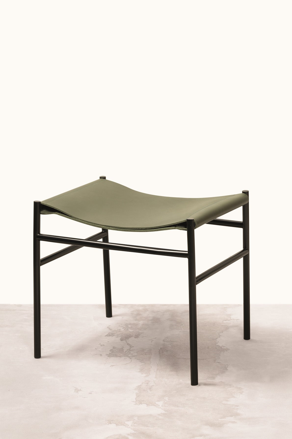 Rabitti 1969 Caballé Pouf | Two folded sheets of saddle leather affixed to a metal frame | Designed to adapt perfectly to the sitter's body for ultimate comfort | Design by Simone Fanciullacci | Elegant and comfortable seating | Home Decor and Furniture | 2Jour Concierge, your luxury lifestyle shop