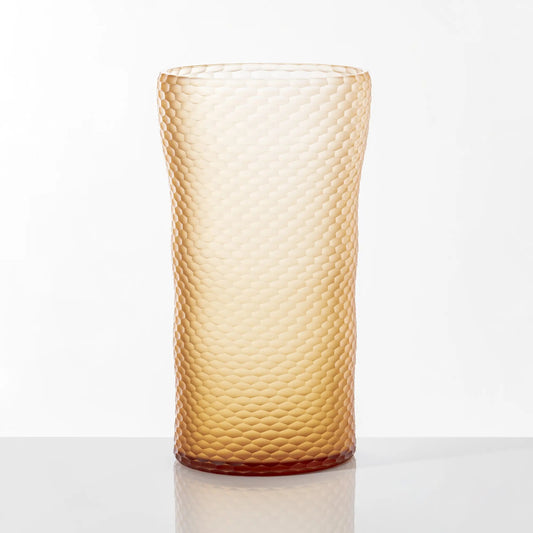 Battuto A Nido D’ape Vase by Venini | Not linear but wavy, featuring a textured surface with small hexagons resembling a honeycomb or ancient handmade textiles | Inspired by nature, designed by Carlo Scarpa, sculpted by master glass grinders | Made of Murano glass in the brand-new Peach variant | Color: Pesca | Designer: Carlo Scarpa | Collection: Pesca | Limited edition of 99 pieces | Home Decor Vases | 2Jour Concierge, your luxury lifestyle shop