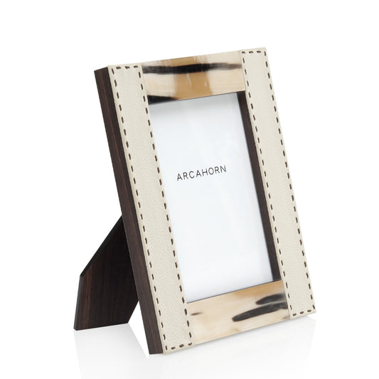 Arcahorn Dorotea Picture Frame | Glossy Horn and Aida Pebbled Leather in Ice-Cream with Handmade Dark Brown Stitching | Matte Amara Ebony Veneer Rim and Back | Designed by Filippo Dini | Ideal for Yachts and Offices | Explore Luxury Home Accessories at 2Jour Concierge, #1 luxury high-end gift & lifestyle shop