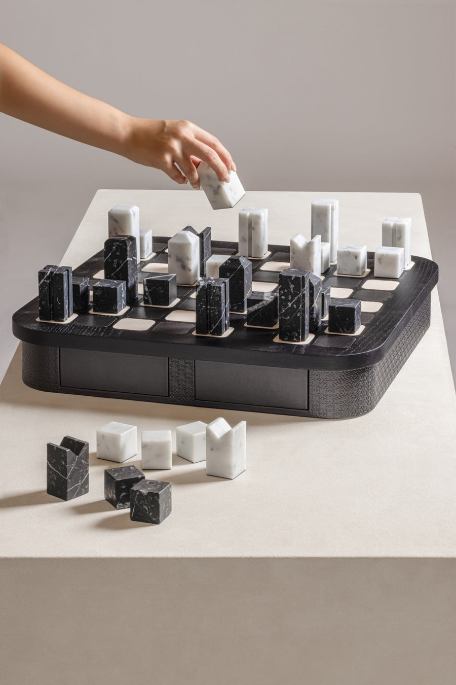 Giobagnara x Elie Saab Monogram Big Chess Game Set | Wood structure with fine leather inserts on top and a leather base featuring the Elie Saab Monogram pattern | Base encases magnetic drawers for storing playing pieces | Includes two sets of chess pieces made from white Carrara and black Marquinia marbles | Elegant and luxurious chess set | Home Decor and Games | 2Jour Concierge, your luxury lifestyle shop