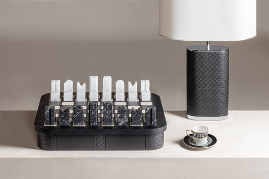 Giobagnara x Elie Saab Monogram Big Chess Game Set | Wood structure with fine leather inserts on top and a leather base featuring the Elie Saab Monogram pattern | Base encases magnetic drawers for storing playing pieces | Includes two sets of chess pieces made from white Carrara and black Marquinia marbles | Elegant and luxurious chess set | Home Decor and Games | 2Jour Concierge, your luxury lifestyle shop
