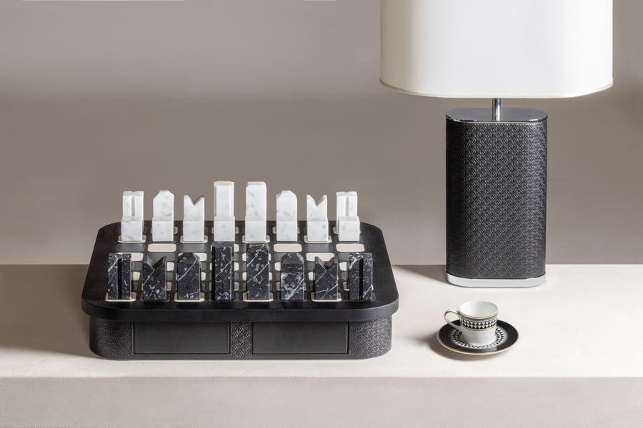 Giobagnara x Elie Saab Monogram Big Chess Game Set | Wood structure with fine leather inserts on top and a leather base featuring the Elie Saab Monogram pattern | Base encases magnetic drawers for storing playing pieces | Includes two sets of chess pieces made from white Carrara and black Marquinia marbles | Elegant and luxurious chess set | Home Decor and Games | 2Jour Concierge, your luxury lifestyle shop