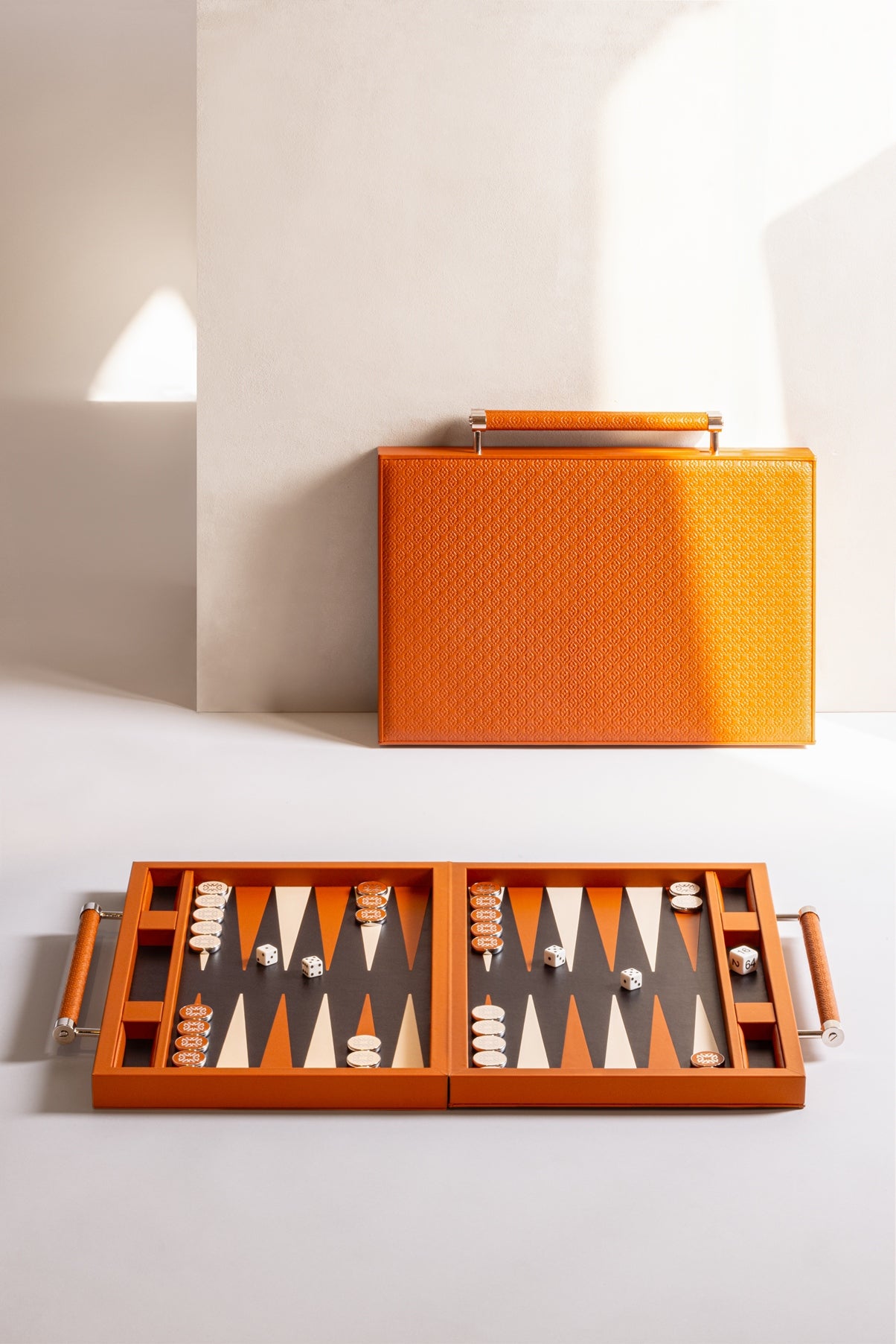 Giobagnara x Elie Saab Monogram Backgammon Case With Handles | Leather-covered case featuring the Elie Saab monogram pattern and inlaid leather playing field | Inner dividers hold two sets of polished palladium backgammon checkers with leather inserts and shiny silver debossed decorations | Includes 4 dice and a doubling cube | Stylish and sophisticated game case | Home Decor and Games | 2Jour Concierge, your luxury lifestyle shop