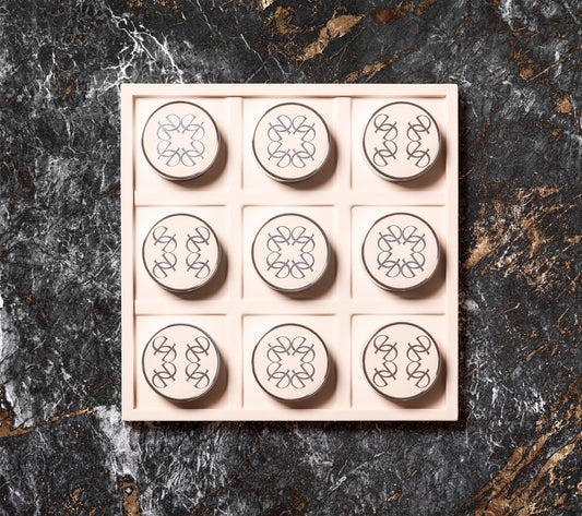 Giobagnara x Elie Saab Ecusson Tic Tac Toe | Leather tray with dividers featuring the Elie Saab Monogram pattern | Includes polished palladium playing pieces with leather inserts and shiny silver debossed decorations | Games and Entertainment | 2Jour Concierge, your luxury lifestyle shop