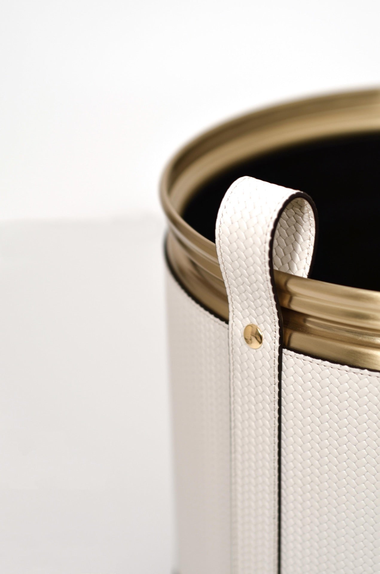 Pinetti | Leather-Covered Cachepot with Wheels: Leather-covered metal cachepot with handle and wheels, in two sizes and chrome, satin brass, or burnished finish | Living Room / Cachepots | 2Jour Concierge, your luxury lifestyle shop | luxury cachepot, designer plant pot cover, leather cachepot, Italian leather home accessories, premium indoor plant holder, Pinetti leather objects, high-end living room decor, leather plant pot, luxury interior planter, designer cachepot with wheels