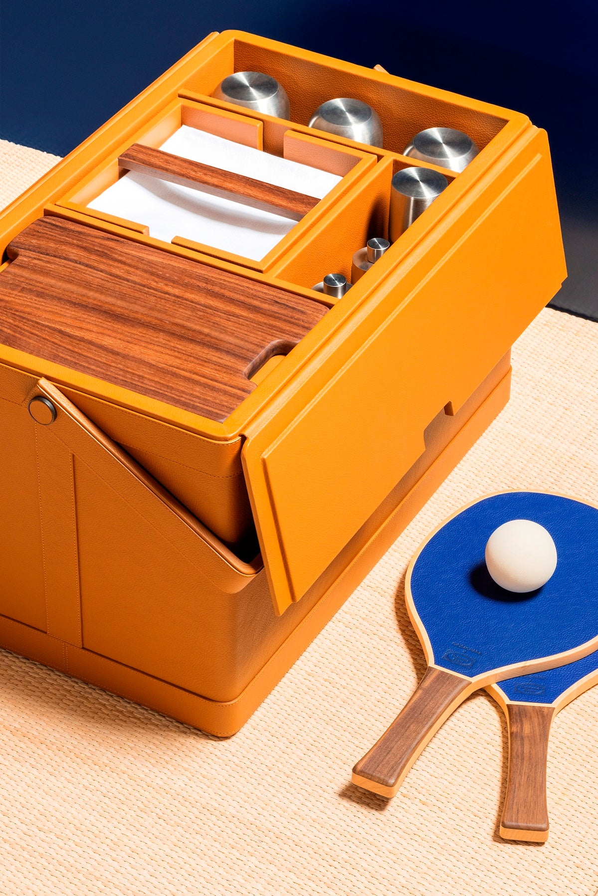 Giobagnara x Poltrona Frau picnic trunk | Leather-covered structure with tilting solid handle, designed for portability and elegance | Fully equipped with a complete picnic set including borosilicate glasses, thermoses, food containers, porcelain plates and cups, cutlery, and more | Walnut chopping board, fine cotton accessories, and leather-covered grinders included | Entirely made in Pelle Frau® | Home accessories & travel essentials | 2Jour Concierge, your luxury lifestyle shop