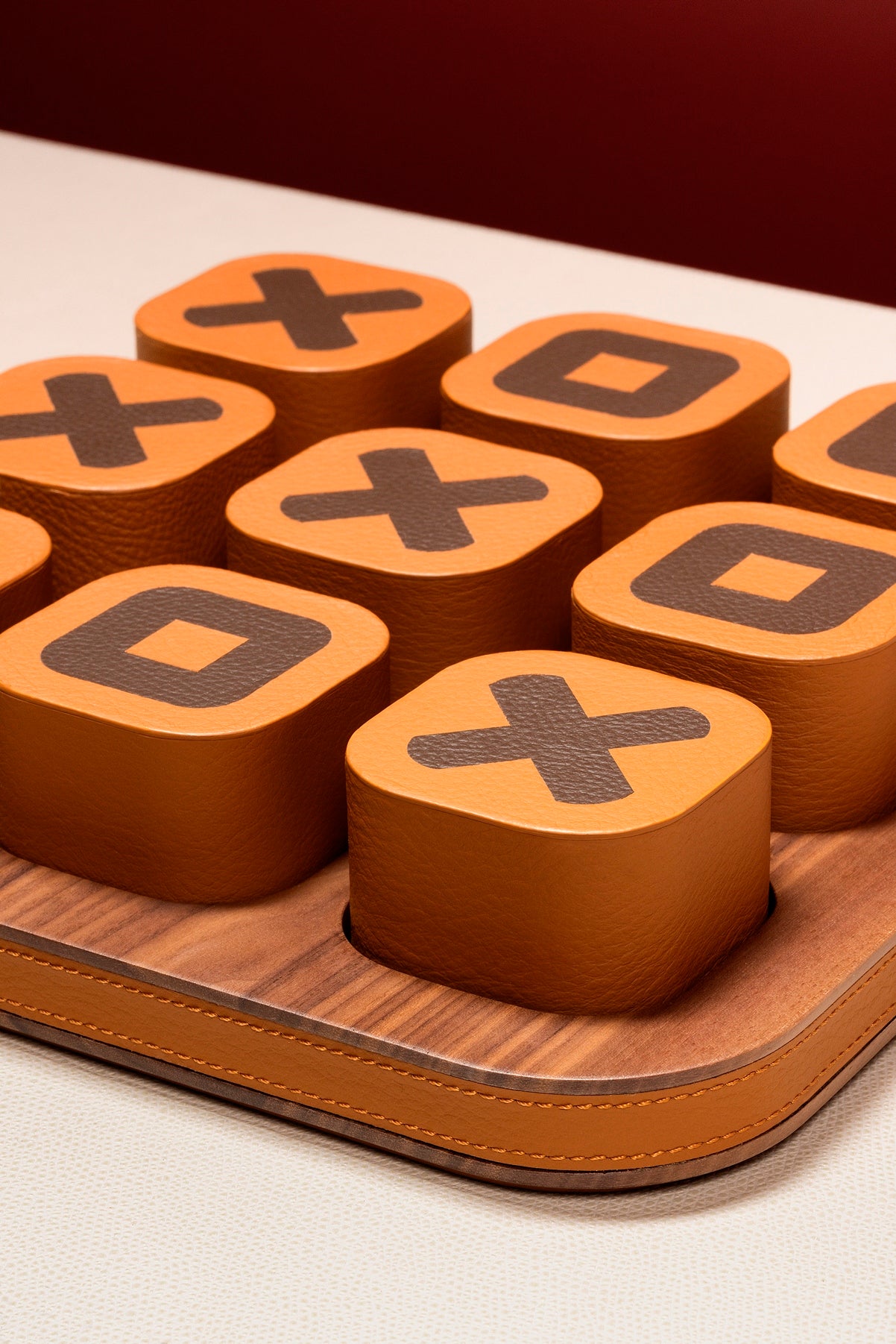 Giobagnara x Poltrona Frau tic tac toe | Leather-covered playing pieces with inlaid graphic motifs | Walnut wood base adorned with refined leather detailing | A luxurious twist on a classic game | Entirely made in Pelle Frau® | Home decor & game sets | 2Jour Concierge, your luxury lifestyle shop