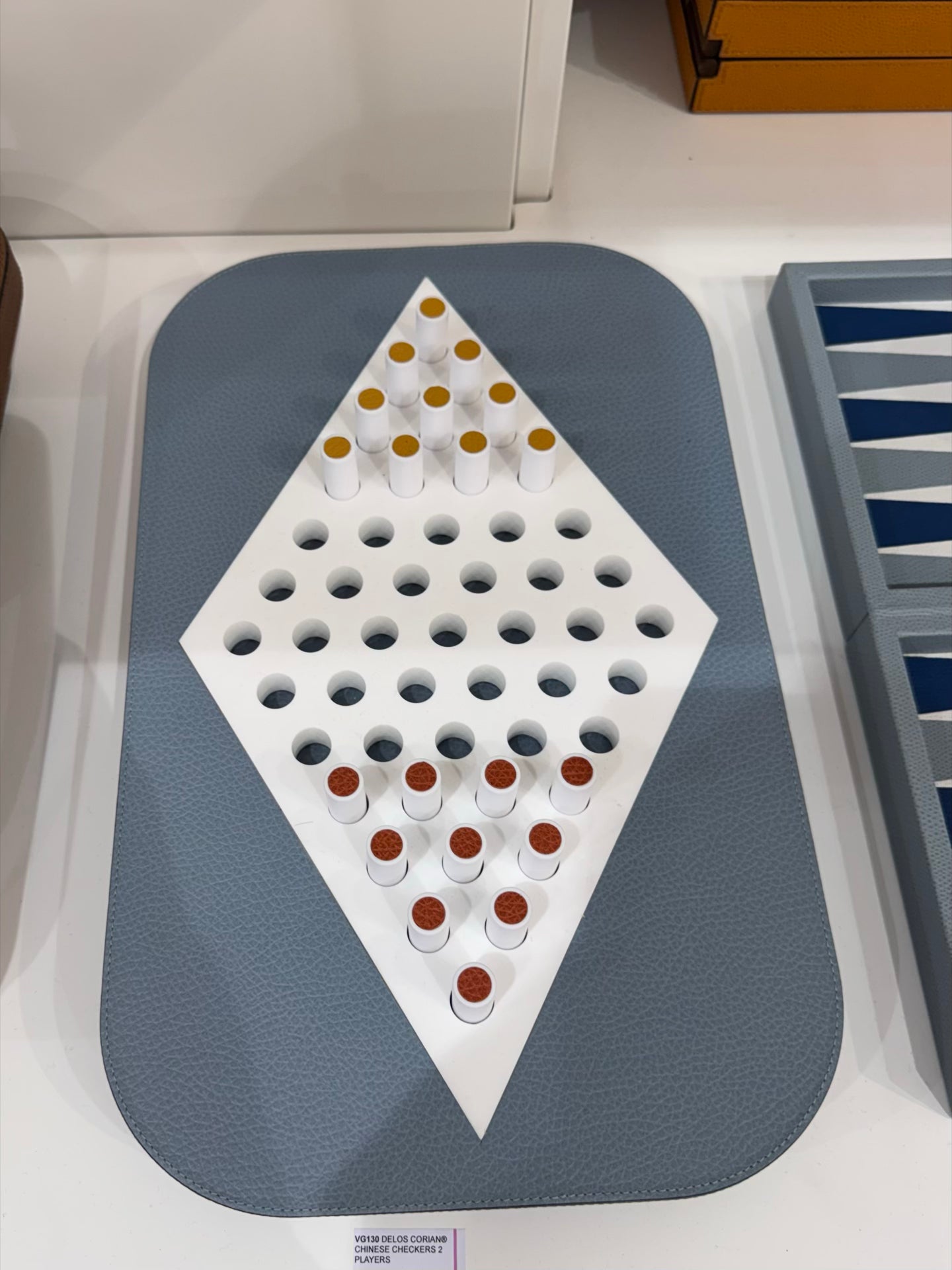 Giobagnara | Delos Chinese Checkers Set Corian®: Leather-covered Corian® board with Corian® playing pieces and leather inserts | Game Room | 2Jour Concierge, your luxury lifestyle shop | luxury chinese checkers Corian, Giobagnara Delos, Corian game set, Italian designer board game