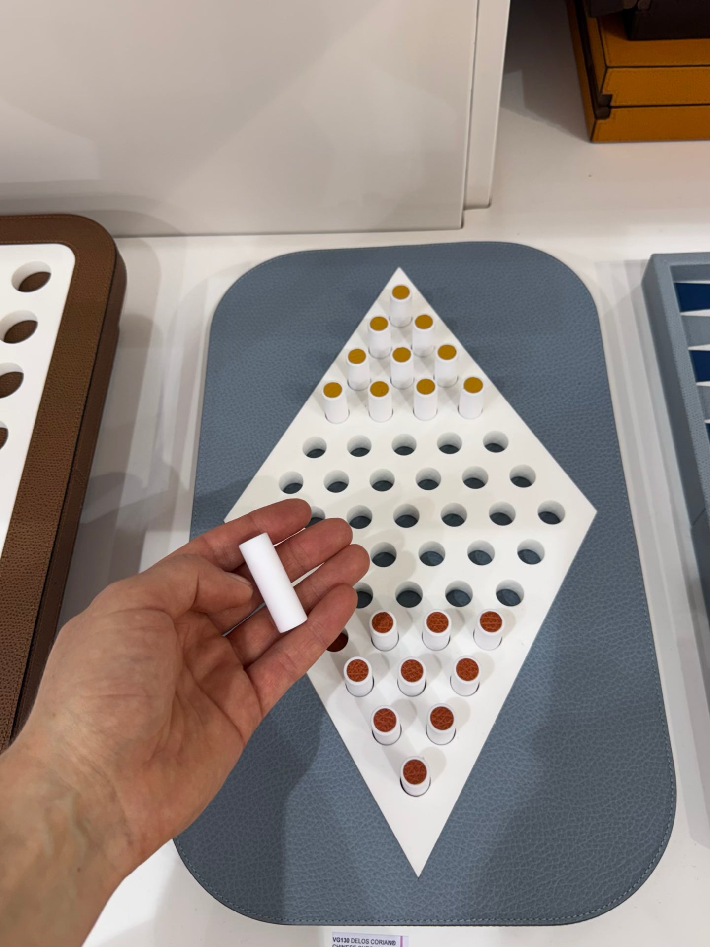 Giobagnara | Delos Chinese Checkers Set Corian®: Leather-covered Corian® board with Corian® playing pieces and leather inserts | Game Room | 2Jour Concierge, your luxury lifestyle shop | luxury chinese checkers Corian, Giobagnara Delos, Corian game set, Italian designer board game