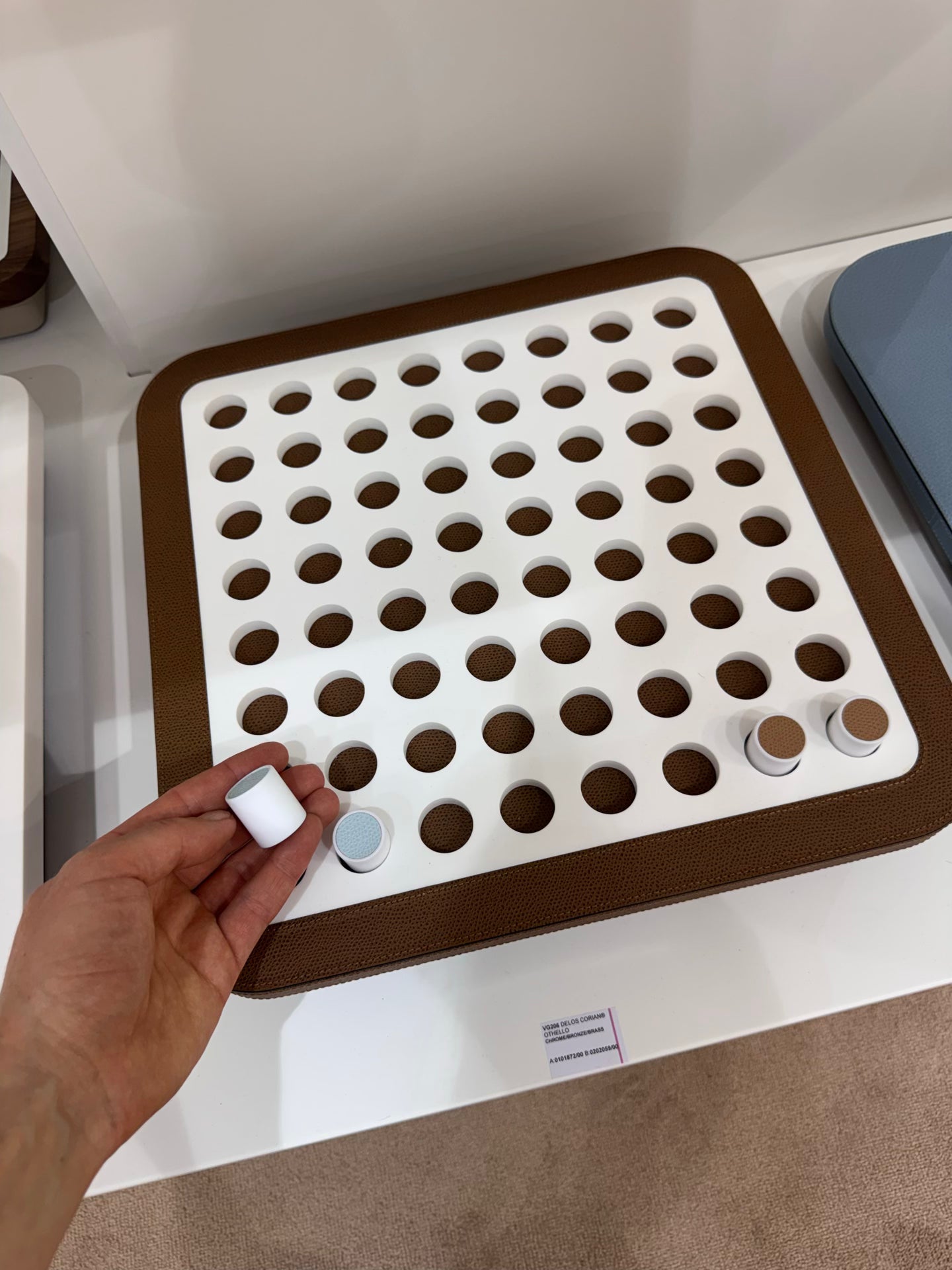 Giobagnara | Delos Othello Game Set Corian®: Corian® leather-covered board with Corian® playing pieces and leather inserts | Game Room | 2Jour Concierge, your luxury lifestyle shop | luxury othello Corian, Giobagnara Delos, Corian game board, Italian designer game
